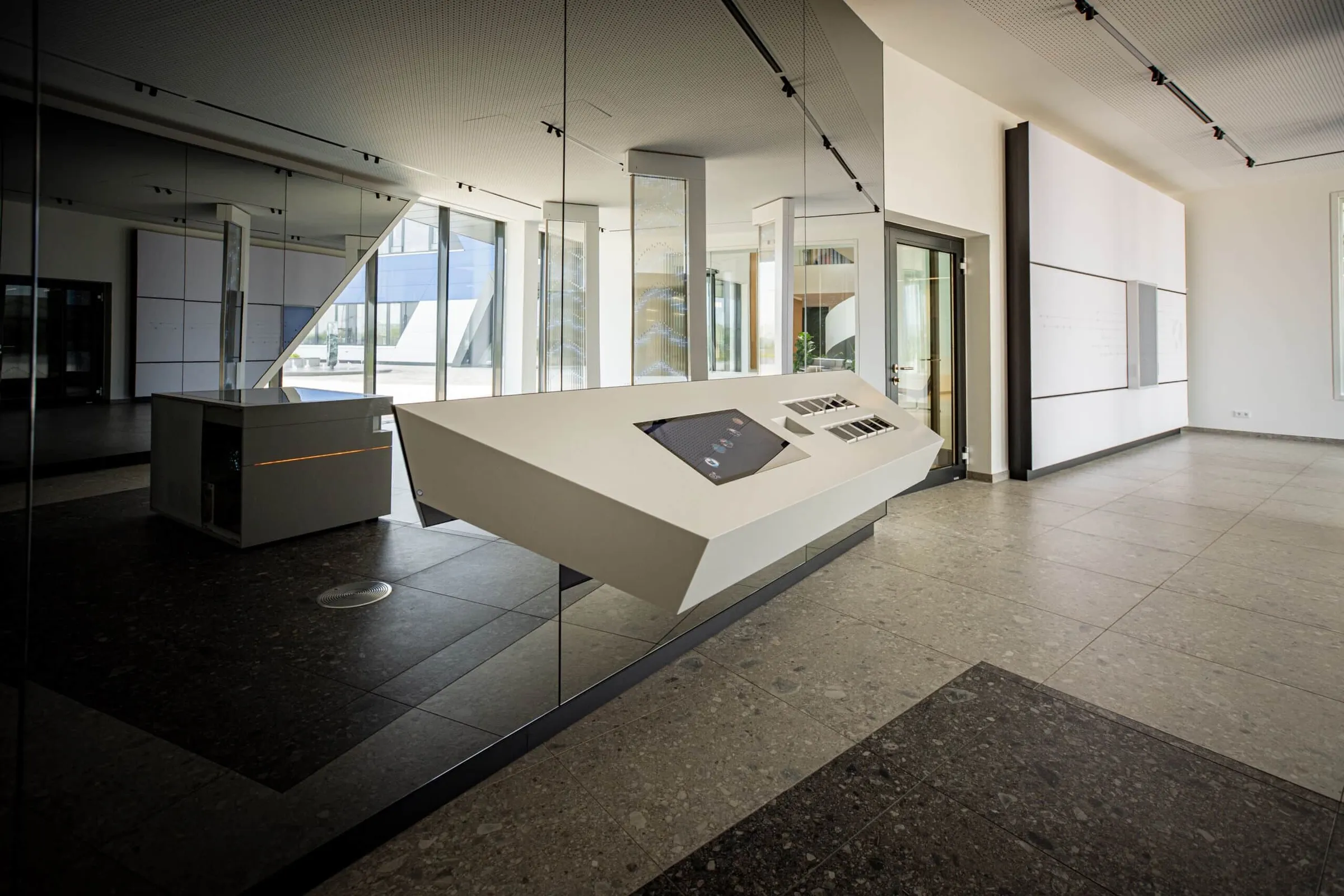 Showroom design with mirrored surfaces and interactive stations