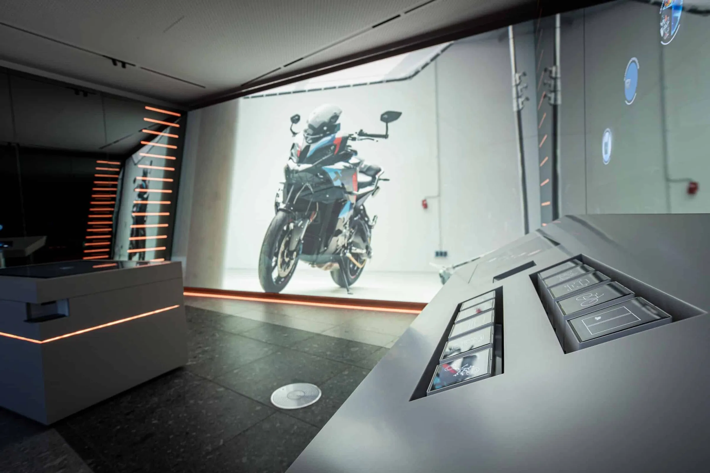 Immersive showroom with wall projection and multi-touch stations