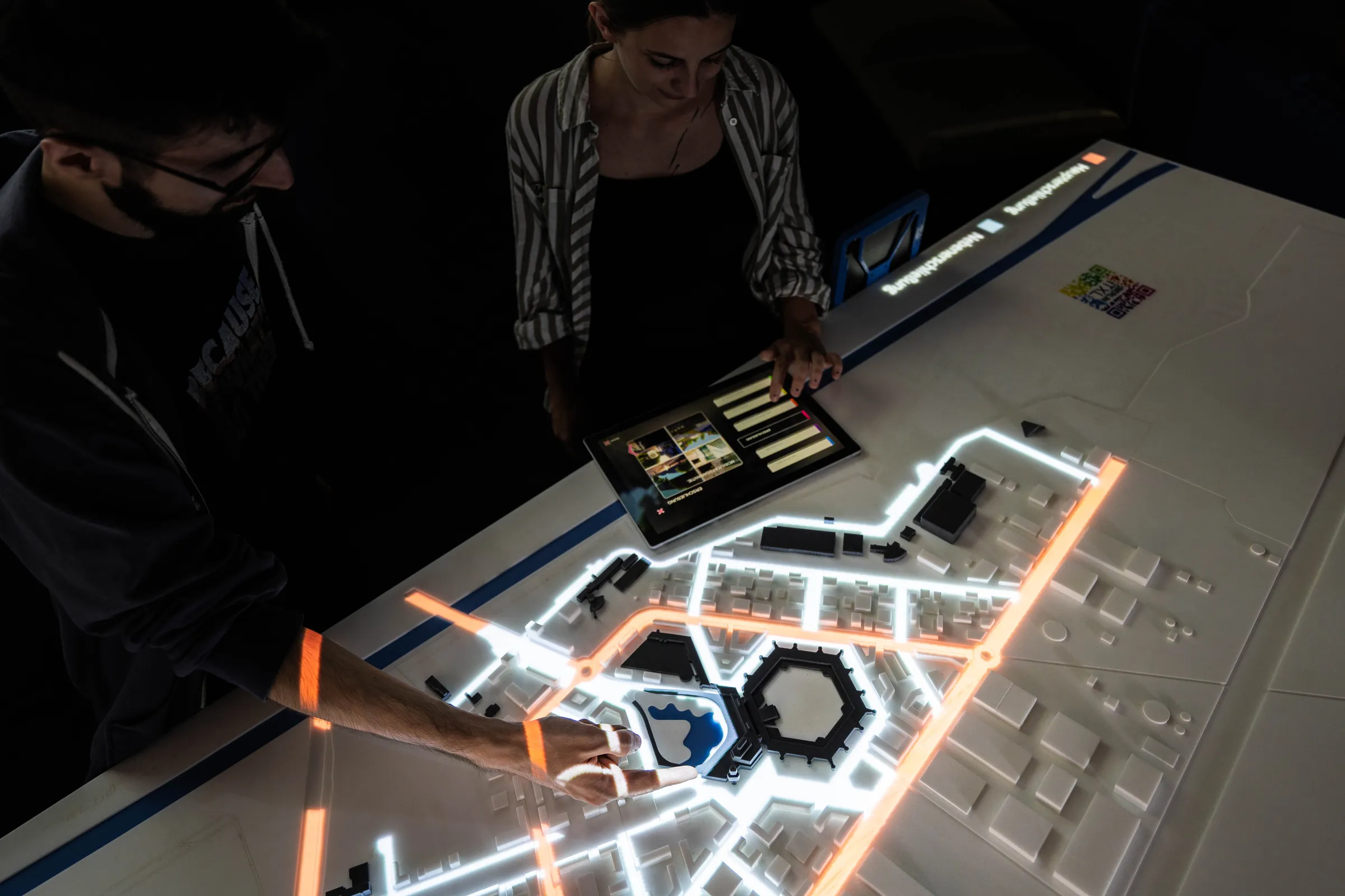 The physical city model is enhanced by precise projections and a digital control system